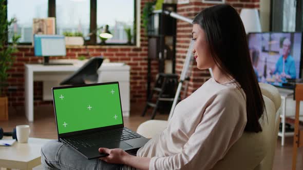 Young Adult Person Sitting on Couch While Using Laptop Having Chroma Key Isolated Background