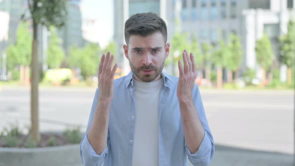 Outdoor Portrait of Angry Young Man Arguing