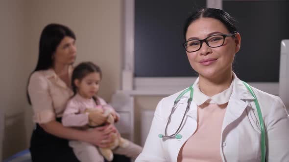 Portrait of Positive Woman Doctor in Hospital Ward