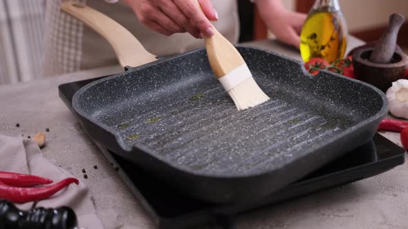 Woman Pouring Cooking Olive Oil on the Frying Pan