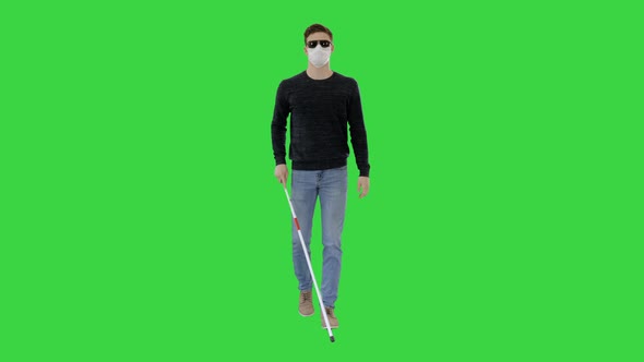 Blind Man in Face Mask and in Dark Glasses with Walking on a Green Screen, Chroma Key