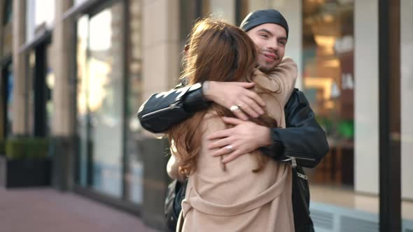 Happy Gay Man Hugging Woman on City Street Talking Smiling