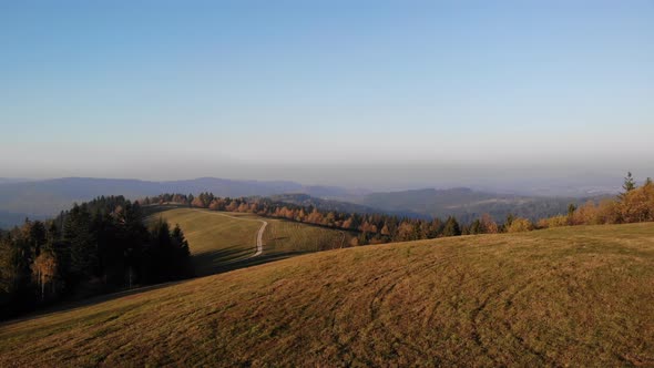 Flight over autumn mountains in the light of the setting sun.