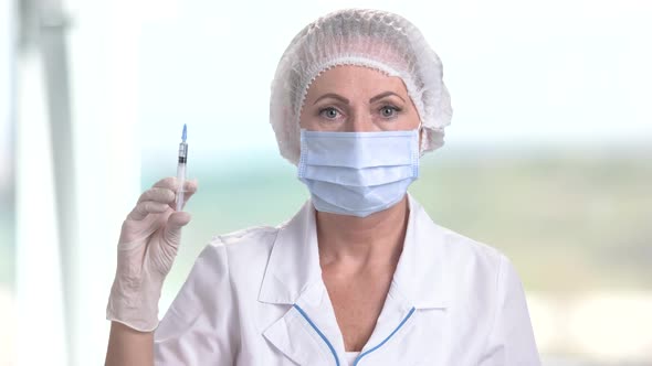 Nurse or Doctor Holding Medical Syringe