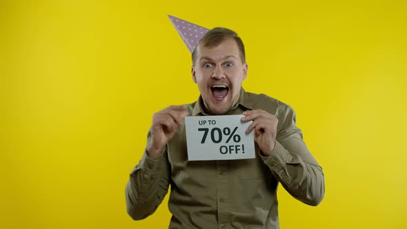 Shocked Store Client. Man Showing Up To 70 Percent Off Inscriptions Signs. Black Friday Concept