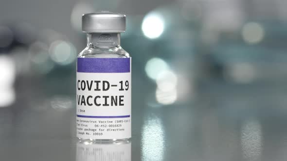 Covid-19 Coronavirus vaccine vial in medical lab with syringe