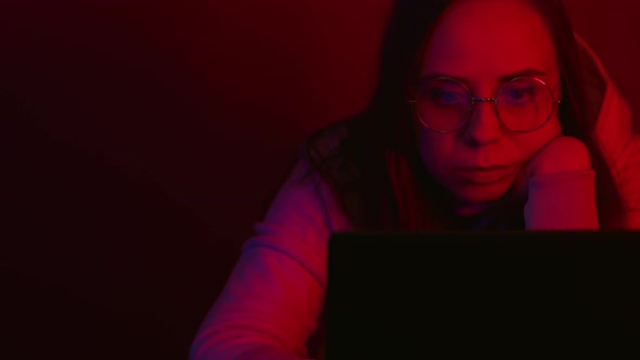 Young Woman Using Laptop in Studio In the Night