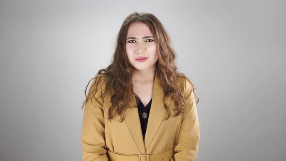 Woman Stands with Crossed Arms and Than Get Perplexed By Unpleasant News