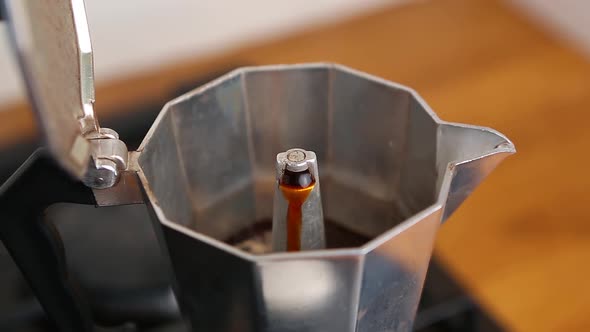 Geyser coffee maker machine brews aromatic caffeine beverage for breakfast in closeup footage clip