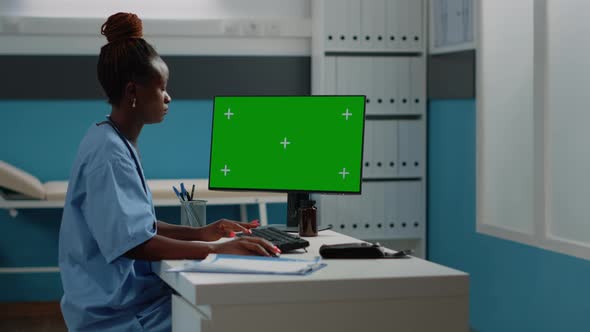 Medical Assistant Using Horizontal Green Screen on Computer