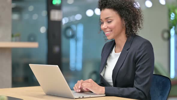 Talking African Businesswoman Doing Video Chat at Work