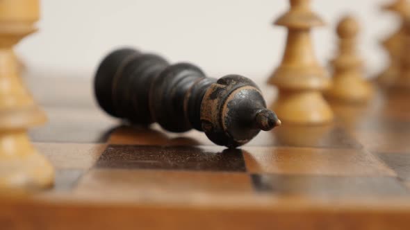 Slow motion of black  player king fall on chequered fields close-up 1920X1080 HD footage - Game ends alt