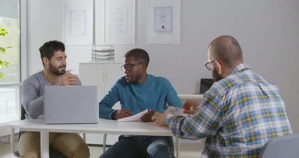 Diverse Business Partners Interviewing Job Candidate in Modern Office