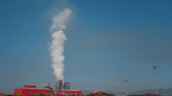 Air pollution of Furniture Factory. Smoke coming from the pipe.