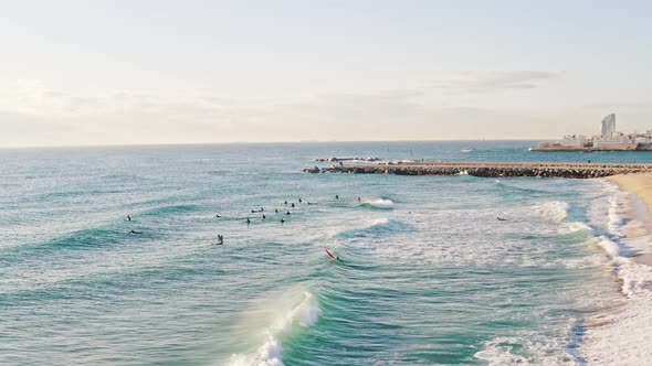 Wide Aerial Shot of Big Surfers Group at Sea Bay