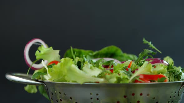 Fresh Salad Flying to Colander in Super Slow Motion