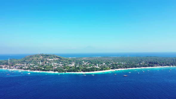 Aerial view of Gili Trawangan tropical island, vacation resorts white sandy beach surrounded by blue