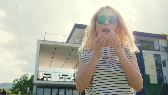 Confident Blond Girl From Below Looking Down at the Camera