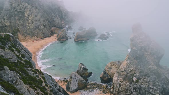 Cliffs at Praia Da Ursa Beach in Morning Fog. Sintra, Portugal