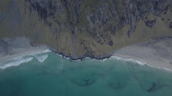 Aerial view overlooking the Kvalvika and Vestervika beaches, in Lofoten, Norway - high angle, pull b