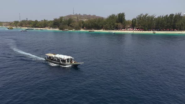 Boat Loaded With Trash For Recycling Leaving Gili Trawangan Island In Indonesia - Aerial Drone Shot