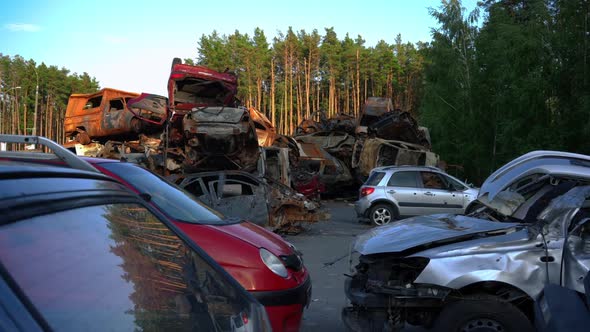 Wide Shot Abandoned Car with Bullet Holes and Burnt Down Automobiles on Dump Outdoors