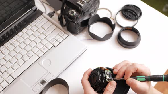 Man Repairs Camera Lens Autofocus Motor Tools