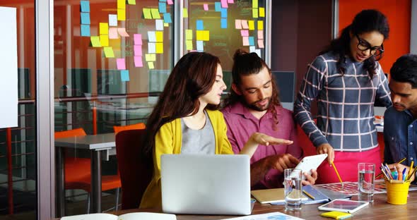 Executives interacting with each other while working