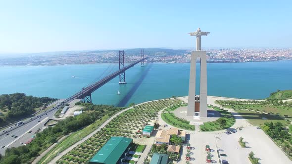 Aerial view of Sanctuary of Christ the King overlooking Lisbon and 25 de Abril Bridge connecting Lis