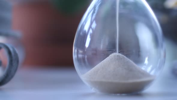 Hourglass sand falling in slow motion