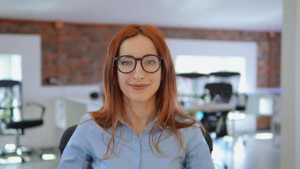 Portrait Redhead Woman Showing Smile at Workplace