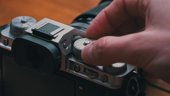 Man's Hands Turn the Aperture Wheel on a Vintage Camera Closeup