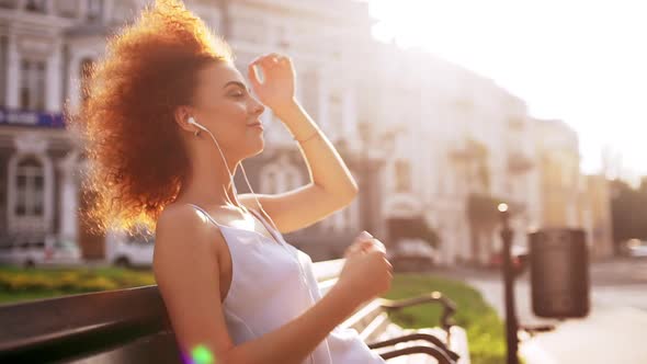 Beautiful Girl Smiling Enjoying Relaxing Sitting on Bench Outside Slow Motion