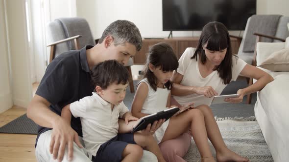 Family Couple and Two Kids Using Digital Tablets