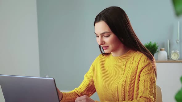 Attractive Woman Communicates By Video Communication Using Laptop