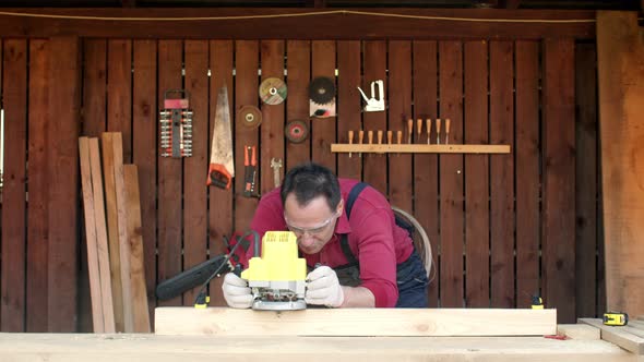 Woodworker Processes Wood with a Milling Machine in His Carpentry Workshop