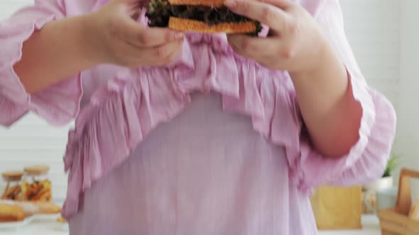 Close-up shot of Overweight woman eating a sandwich salads for dieting weight loss.