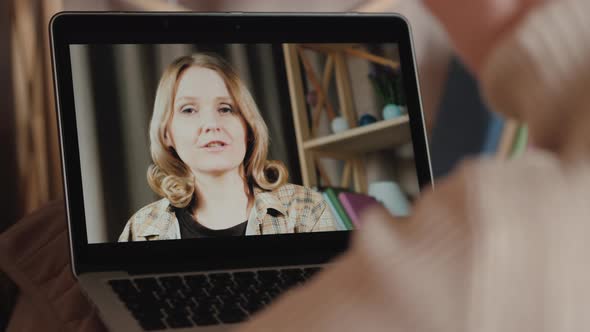 A Woman Communicates with a Friend Via Video Call