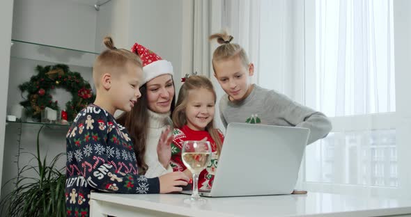 New Year's Concept Mom Her Children Christmas Costumes Make Online Call Laptop