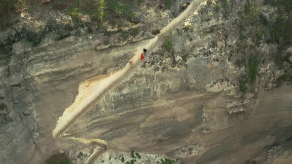 Tourists People Climbs and Coming Down a Steep Staircase Cut Down in a Rock at the Diamond Beach