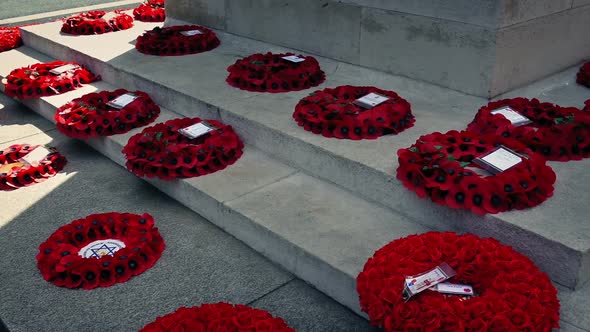 Pan Across Poppy Wreaths At War Memorial