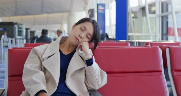 Businesswoman sleep on the wait area at the airport