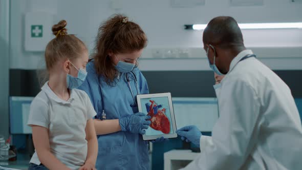 Woman Nurse Showing Cardiology Image on Digital Tablet