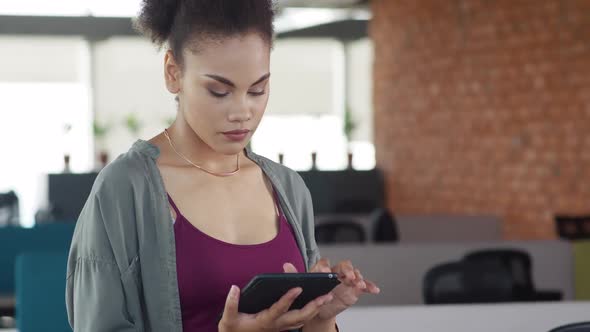 Young African Woman in Modern Office Business Woman Uses the Tablet