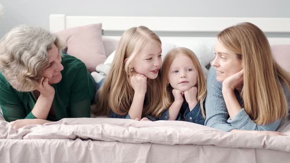 Three Generations of Women Laying on the Bed