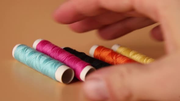 Man put Colorful threads , Sewing threads