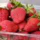 Close up of fresh strawberries in plastic box on 360 degree rotating stand - VideoHive Item for Sale