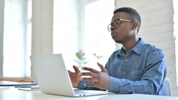 Upset Young African Man reacting to Loss on Laptop