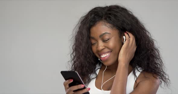 Happy Ethnic Woman Listening To Music and Dancing