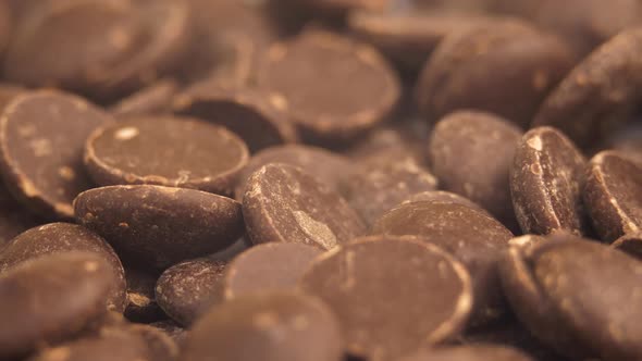 Chocolate Chips Drops Rotating Background. Food Concept.